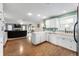 Open concept kitchen with white cabinets, wood floors and an opening to the living room at 1891 W 300 N, Anderson, IN 46011