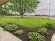 Well-manicured landscaping and garden beds frame the view of the home and front yard at 1891 W 300 N, Anderson, IN 46011