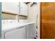 Bright laundry room features a washer, dryer, storage cabinets, and convenient cleaning supplies at 1891 W 300 N, Anderson, IN 46011