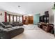 Spacious living room featuring a large sectional couch, flat screen TV, and bright natural lighting at 1891 W 300 N, Anderson, IN 46011