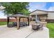 Inviting patio with outdoor seating, a gazebo, and a view of the well-manicured backyard and outbuilding at 1891 W 300 N, Anderson, IN 46011
