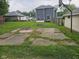 Backyard view showcasing a basketball hoop, detached garage, and patio area, offering recreational space at 203 W 3Rd St, Sheridan, IN 46069