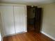 Bedroom featuring hardwood floors, closet and view to second story via open door at 203 W 3Rd St, Sheridan, IN 46069