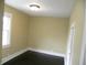 Neutral bedroom with a window, closet, dark wood floor, and baseboard trim at 203 W 3Rd St, Sheridan, IN 46069