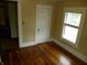 Bedroom featuring wood floors, a window and view to other rooms via the doorway at 203 W 3Rd St, Sheridan, IN 46069