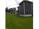 A well-maintained home featuring attractive vinyl siding and a lush, green lawn, plus a car parked out front at 203 W 3Rd St, Sheridan, IN 46069