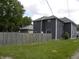 Exterior view of home with gray siding, fenced in backyard and greenery at 203 W 3Rd St, Sheridan, IN 46069
