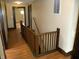 Hallway featuring wood railing and wood floors with access to other rooms at 203 W 3Rd St, Sheridan, IN 46069