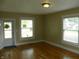 Living room featuring hardwood floors, neutral walls, and natural light from two windows at 203 W 3Rd St, Sheridan, IN 46069