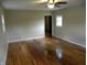 Large living room with bright hardwood floors, baseboard trim, and natural light at 203 W 3Rd St, Sheridan, IN 46069