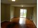 Bright living room featuring hardwood floors and sliding glass doors to the backyard at 203 W 3Rd St, Sheridan, IN 46069