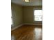 View of the sunlit living room showcasing hardwood floors and a neutral color scheme at 203 W 3Rd St, Sheridan, IN 46069