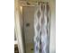 Shower in bathroom with silver trim door and a patterned grey and blue shower curtain at 203 W 3Rd St, Sheridan, IN 46069