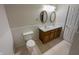 Well-lit bathroom with a double sink vanity, tile flooring, and a toilet at 2035 Theodore Dr, Indianapolis, IN 46214