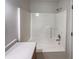 A clean bathroom with a shower-tub combo, a white shower stall, and modern fixtures at 2035 Theodore Dr, Indianapolis, IN 46214
