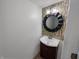 Cozy bathroom with decorative mirror, vanity, and light fixture over mosaic backsplash at 2035 Theodore Dr, Indianapolis, IN 46214