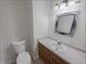 Bathroom features a white vanity with updated fixtures, stylish mirror, and modern lighting at 2035 Theodore Dr, Indianapolis, IN 46214
