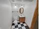 Charming bathroom features a modern vanity, updated fixtures, and black and white tile floor at 2035 Theodore Dr, Indianapolis, IN 46214