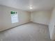 Neutral bedroom features carpeted flooring, one window for natural light, and a door to the hallway at 2035 Theodore Dr, Indianapolis, IN 46214