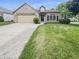 Charming one-story brick home with a well-maintained lawn and an attached garage at 2035 Theodore Dr, Indianapolis, IN 46214