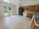 Spacious kitchen with tile floors, wooden cabinets, and stainless steel appliances with a backyard view at 2035 Theodore Dr, Indianapolis, IN 46214