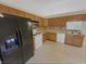 Functional kitchen with wooden cabinets, white appliances, and tile backsplash at 2035 Theodore Dr, Indianapolis, IN 46214