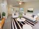 Bright living room with modern furniture, neutral walls, and a vaulted ceiling with a ceiling fan at 2035 Theodore Dr, Indianapolis, IN 46214