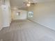 Large living room with carpet flooring, high ceilings, neutral colors, and a big window at 2035 Theodore Dr, Indianapolis, IN 46214