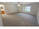 Carpeted main bedroom with a ceiling fan, and a view of the en suite at 2035 Theodore Dr, Indianapolis, IN 46214