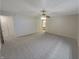 Spacious main bedroom with neutral carpet, ceiling fan, and connecting bathroom access at 2035 Theodore Dr, Indianapolis, IN 46214