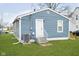 Charming home's backyard featuring an entry door and well-maintained green space at 2209 W 9Th St, Muncie, IN 47302