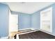 A bright bedroom features gray flooring, a window, and a black and white bed at 2209 W 9Th St, Muncie, IN 47302