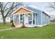 Charming bungalow with blue siding, wood accents, a cozy porch, and a well-manicured lawn at 2209 W 9Th St, Muncie, IN 47302
