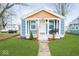 Inviting blue bungalow with a cozy front porch and freshly cut lawn at 2209 W 9Th St, Muncie, IN 47302