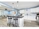 Open kitchen with white cabinetry, stainless steel appliances, and a stylish island overlooking living area at 2209 W 9Th St, Muncie, IN 47302