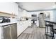 Bright kitchen with stainless steel appliances, white cabinetry, and a stylish tile backsplash at 2209 W 9Th St, Muncie, IN 47302