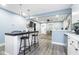 A modern kitchen features a breakfast bar, stainless steel appliances, and an open floor plan at 2209 W 9Th St, Muncie, IN 47302