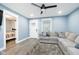 Comfortable living room with a large sectional sofa, light gray floors, and easy access to bedroom at 2209 W 9Th St, Muncie, IN 47302
