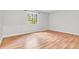 Inviting bedroom featuring wood-look flooring and a large window with lush, leafy views at 2267 Rome Dr # A, Indianapolis, IN 46228