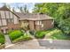 Brick townhouse with a well-kept lawn, lush landscaping, and a stone retaining wall, blending beauty and practicality at 2267 Rome Dr # A, Indianapolis, IN 46228