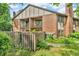 Exterior of condo building featuring a fenced yard and private balcony at 2267 Rome Dr # A, Indianapolis, IN 46228