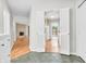Hallway featuring white trim and an entry to kitchen and living area with fireplace at 2267 Rome Dr # A, Indianapolis, IN 46228