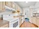 Kitchen with wood cabinets, white appliances, and tile countertops; perfect for cooking at 2267 Rome Dr # A, Indianapolis, IN 46228