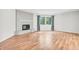 Open living room with a brick fireplace, hardwood floors, and bright natural light at 2267 Rome Dr # A, Indianapolis, IN 46228