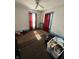 Bedroom with red curtains and blue trimmings in need of repair at 2310 Noble St, Anderson, IN 46016