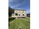 Two-story home featuring a covered front porch, a well-maintained lawn, and mature landscaping at 2310 Noble St, Anderson, IN 46016