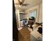 Laundry room with hardwood floor, utility sink and a window with patterned curtains at 2310 Noble St, Anderson, IN 46016