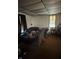 Living room with a brown carpet, ceiling tile and a window with curtains at 2310 Noble St, Anderson, IN 46016