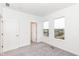 Well-lit bedroom with neutral carpet and large windows offering a city view at 2412 Peoples Dr, Indianapolis, IN 46205