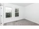 Bright bedroom featuring two windows, neutral carpet, and fresh white paint at 2412 Peoples Dr, Indianapolis, IN 46205